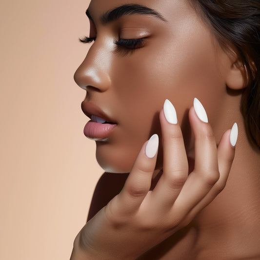 Nude and white press-on nails on diverse hands from InchArt for a salon-style manicure at home.